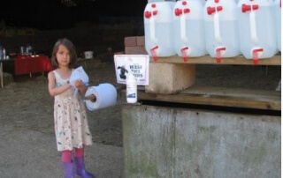 Photo of girl using hand wash facilities at farm