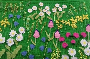 close up of flowers on quilt